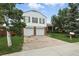 Charming two-story home featuring a two-car garage, brick accents, and mature landscaping at 2527 S Ouray Way, Aurora, CO 80013