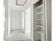 Hallway with open storage shelves and access to other rooms at 2527 S Ouray Way, Aurora, CO 80013