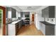 This bright kitchen has gray cabinets, stainless steel appliances and hardwood floors at 2527 S Ouray Way, Aurora, CO 80013
