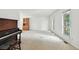 Spacious living room with a piano and two large windows at 2527 S Ouray Way, Aurora, CO 80013