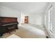 Spacious living room with a piano and two large windows at 2527 S Ouray Way, Aurora, CO 80013