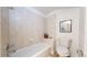 Cozy bathroom featuring a tiled tub/shower, and neutral fixtures, perfect for relaxation and convenience at 203 S Jackson St, Denver, CO 80209