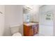 Bright bathroom featuring a single vanity and a view into the adjoining room through an open doorway at 203 S Jackson St, Denver, CO 80209