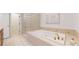 Elegant bathroom with soaking tub and glass block window, offering a luxurious and private retreat at 203 S Jackson St, Denver, CO 80209