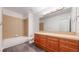 Bathroom with a single sink vanity with a large mirror and a shower-tub combo at 203 S Jackson St, Denver, CO 80209