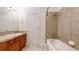 Well-lit bathroom featuring a vanity with storage, tiled flooring, and a tiled shower-tub combination at 203 S Jackson St, Denver, CO 80209