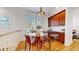 Bright dining area with hardwood floors, modern lighting, and a round glass table at 203 S Jackson St, Denver, CO 80209