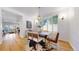 Open dining room featuring a modern chandelier, stylish table set and bay window at 203 S Jackson St, Denver, CO 80209