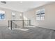 Spacious loft area with gray carpeting and multiple windows at 8570 Eagle River St, Littleton, CO 80125