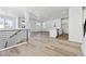 Open concept main living area with kitchen island and gray vinyl plank flooring at 8570 Eagle River St, Littleton, CO 80125