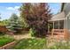 Backyard featuring a screened-in porch, mature trees, a privacy fence, and a well maintained lawn at 10284 Royal Eagle St, Highlands Ranch, CO 80129