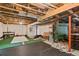 Unfinished basement area with rubber and turf flooring, an exposed ceiling, and storage at 10284 Royal Eagle St, Highlands Ranch, CO 80129