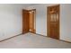 Bedroom with neutral carpet, and a door leading to another bedroom or ensuite bathroom at 10284 Royal Eagle St, Highlands Ranch, CO 80129