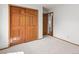 Bright bedroom features neutral carpet, wood trim, and double door closet at 10284 Royal Eagle St, Highlands Ranch, CO 80129