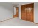 Bedroom offering neutral carpet, and a double door closet leading to adjoining room at 10284 Royal Eagle St, Highlands Ranch, CO 80129