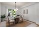 Open dining room with natural light, a modern light fixture, and seating for four at 10284 Royal Eagle St, Highlands Ranch, CO 80129