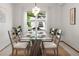 Inviting dining room featuring a glass top table and scenic backyard views through a large window at 10284 Royal Eagle St, Highlands Ranch, CO 80129