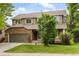 Charming two-story home with brick and siding, well-maintained lawn, and an attached two-car garage at 10284 Royal Eagle St, Highlands Ranch, CO 80129
