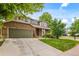 Charming two-story home with brick and siding, well-maintained lawn, and an attached two-car garage at 10284 Royal Eagle St, Highlands Ranch, CO 80129