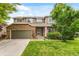 Charming two-story home with brick and siding, well-maintained lawn, and an attached two-car garage at 10284 Royal Eagle St, Highlands Ranch, CO 80129