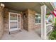 Cozy front porch with brick siding and a white storm door, perfect for relaxing at 10284 Royal Eagle St, Highlands Ranch, CO 80129