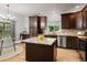Well-lit kitchen with wood cabinets, granite countertops, an island, and stainless steel appliances at 10284 Royal Eagle St, Highlands Ranch, CO 80129