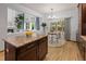 Kitchen island with granite counters, breakfast nook, and seamless living area at 10284 Royal Eagle St, Highlands Ranch, CO 80129