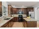 Kitchen boasts granite counters, stainless steel appliances, and dark wood cabinets at 10284 Royal Eagle St, Highlands Ranch, CO 80129