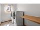 Bright laundry room with side-by-side washer and dryer, a window, and a folding shelf at 10284 Royal Eagle St, Highlands Ranch, CO 80129