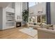 Bright living room features soaring ceilings, large windows, a fireplace, and hardwood floors at 10284 Royal Eagle St, Highlands Ranch, CO 80129