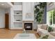 Bright living room features soaring ceilings, large windows, a fireplace, and hardwood floors at 10284 Royal Eagle St, Highlands Ranch, CO 80129