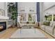 Bright living room features soaring ceilings, large windows, a fireplace, and hardwood floors at 10284 Royal Eagle St, Highlands Ranch, CO 80129