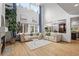 Bright living room features soaring ceilings, large windows, a fireplace, and hardwood floors at 10284 Royal Eagle St, Highlands Ranch, CO 80129