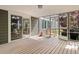 Spacious screened-in porch boasts wood floors, sliding door access and seamless transition from the outdoors at 10284 Royal Eagle St, Highlands Ranch, CO 80129
