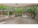 Sun-drenched screened porch featuring an outdoor exit door, wood flooring, and unobstructed views of the yard at 10284 Royal Eagle St, Highlands Ranch, CO 80129