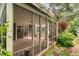 Light filled screened-in porch showcasing wood floors, sliding glass doors and natural views of the backyard at 10284 Royal Eagle St, Highlands Ranch, CO 80129