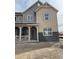 Two-story home with a mix of board siding, brick accents, and a welcoming front porch at 15218 Detroit St, Thornton, CO 80602