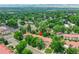 Aerial shot showcasing a condo surrounded by lush trees, city and nearby lake at 2665 S Sheridan Ct, Lakewood, CO 80227