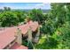 Aerial view showcasing a condo with a red tile roof and surrounding green spaces at 2665 S Sheridan Ct, Lakewood, CO 80227
