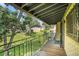 Private balcony with iron fencing offering views of a grassy common area and mature trees at 2665 S Sheridan Ct, Lakewood, CO 80227