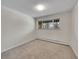 Bright bedroom featuring carpet flooring and a window at 2665 S Sheridan Ct, Lakewood, CO 80227