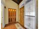 Warm entryway with brick flooring, wooden doors, and decorative glass accents that brings in natural light at 2665 S Sheridan Ct, Lakewood, CO 80227