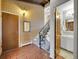 Entryway with tiled floor, wood door, and staircase at 2665 S Sheridan Ct, Lakewood, CO 80227