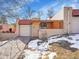 Neat brick ranch home with attached garage and snow-covered yard at 2665 S Sheridan Ct, Lakewood, CO 80227