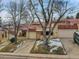 Wider view of the house from the street, including landscaping at 2665 S Sheridan Ct, Lakewood, CO 80227