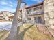 Rear view of the property showing landscaping and patio at 2665 S Sheridan Ct, Lakewood, CO 80227