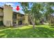 Brick condo featuring dual balconies, a ground floor patio, and a lush lawn at 2665 S Sheridan Ct, Lakewood, CO 80227