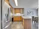 Modern kitchen with stainless steel appliances and wood cabinets at 2665 S Sheridan Ct, Lakewood, CO 80227
