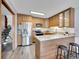 Modern kitchen with stainless steel appliances and breakfast bar at 2665 S Sheridan Ct, Lakewood, CO 80227