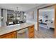 Open concept kitchen flows into living room with peninsula seating at 2665 S Sheridan Ct, Lakewood, CO 80227